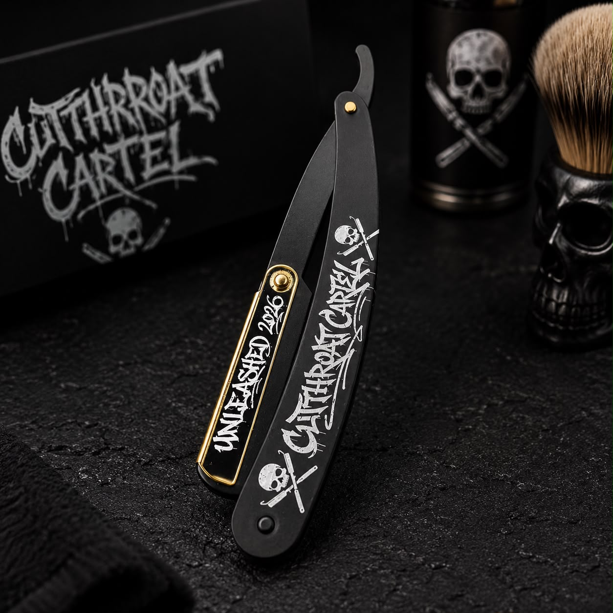 The Black and Gold razor displayed upright at a dark Cutthroat Cartel barber station beside a shaving brush.