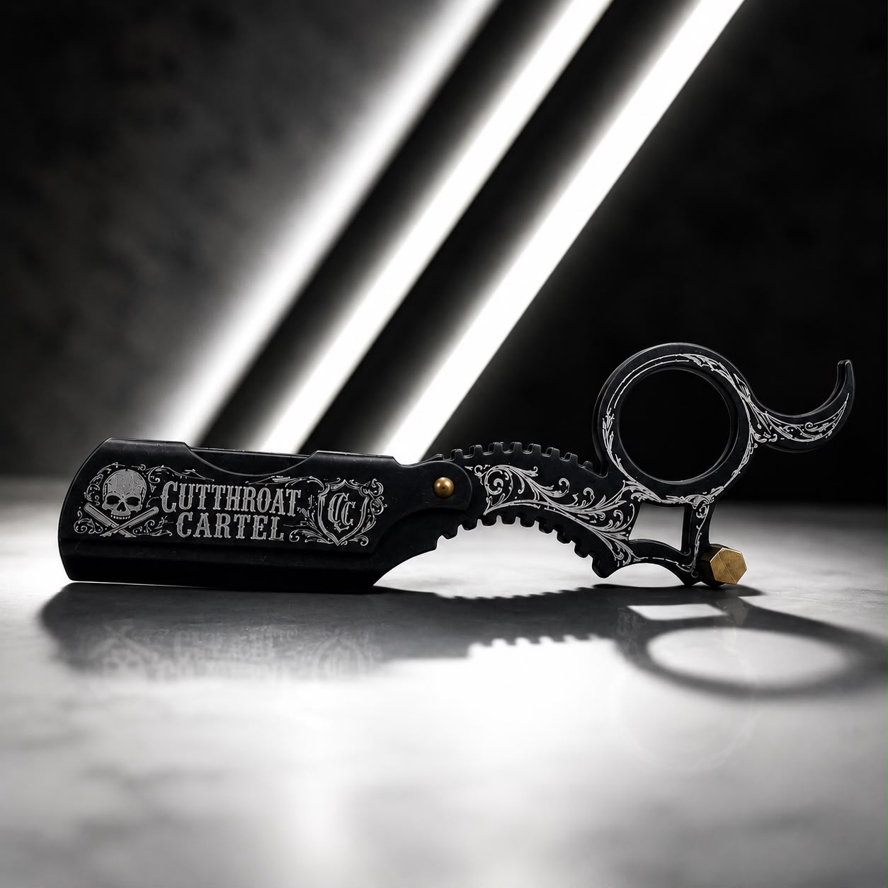 The Gold Ring-Handle Razor photographed open under dramatic studio lighting.